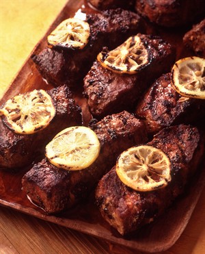 Grilled Veal Tenderloin Steaks with Black Olives background image