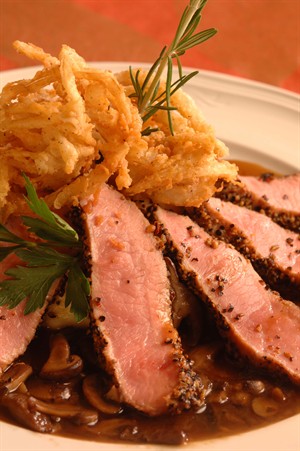 Zesty Peppercorn-Crusted Veal New York Steak with Tabasco Buttermilk Onion Straws and Sartori Parmesan