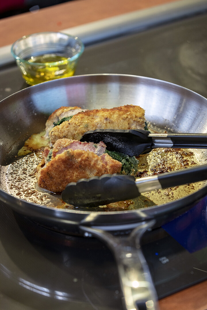 Spinach and Prosciutto Stuffed Veal Rolls Over Polenta background image