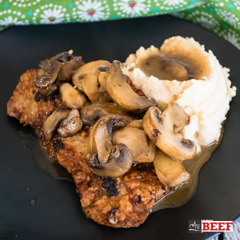 veal Marsala topped with mushroom gravy over potatoes