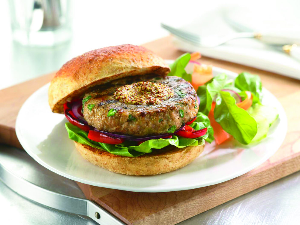 Dijon Veal Burgers plated with side salad garnish on plate