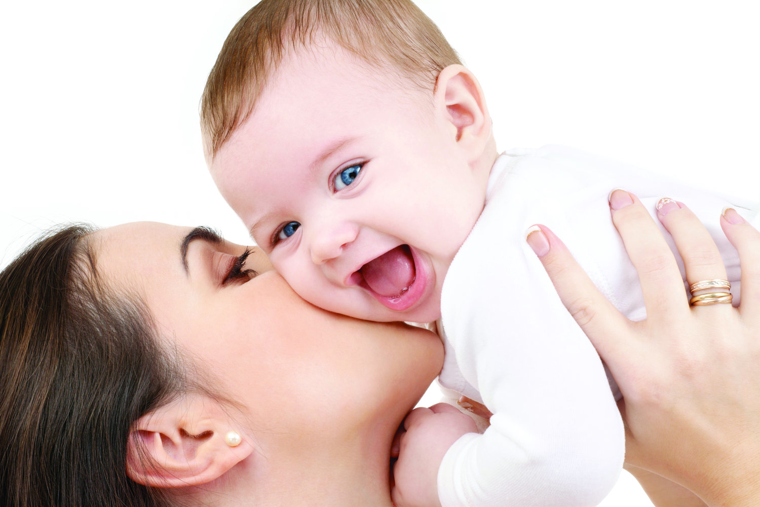 mother kissing smiling baby