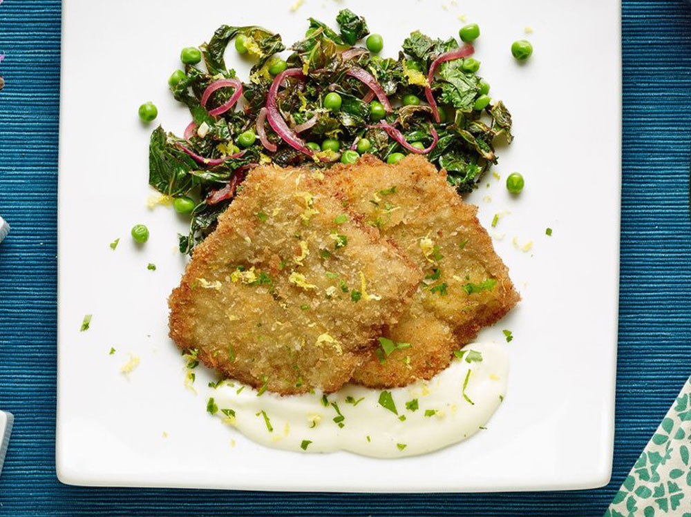 Veal medallions over pea salad with lemon juice and cooked spinach and polenta.