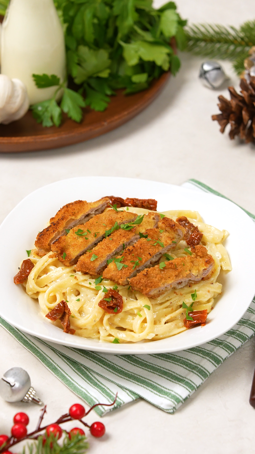 Breaded cutlets sit on a bed of linguine tossed in a garlic cream sauce and garnished with sundried tomatoes