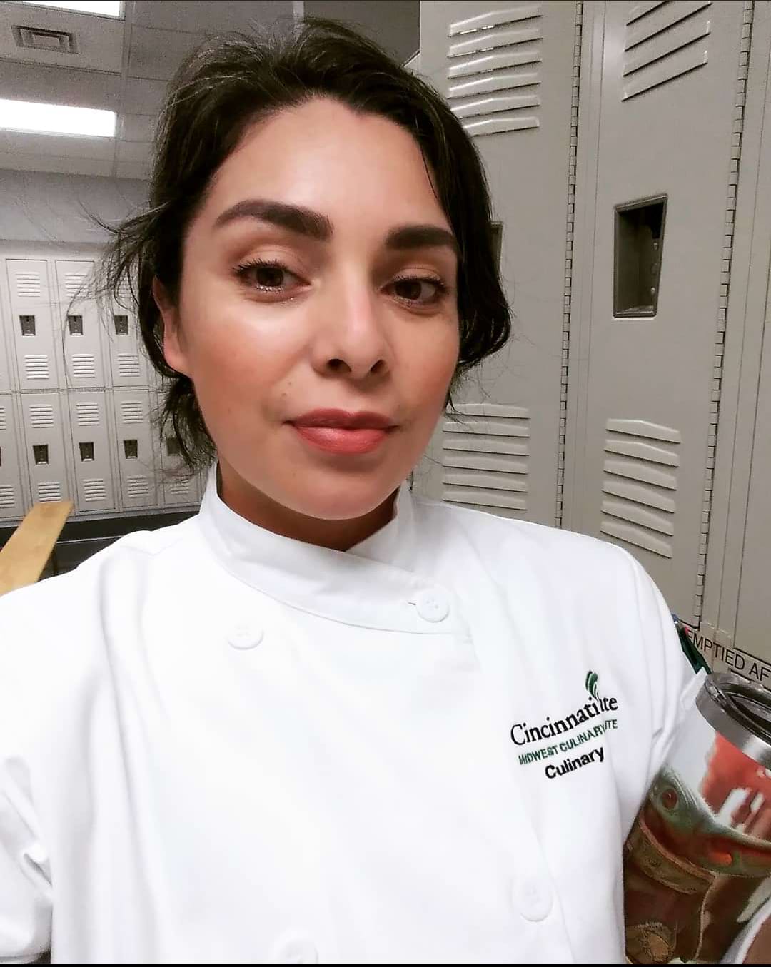 Andrea Lazos stands in her chef coat with her competition entry, as the one of the peoples choice winners of the 2022 National Collegiate Veal Competition.