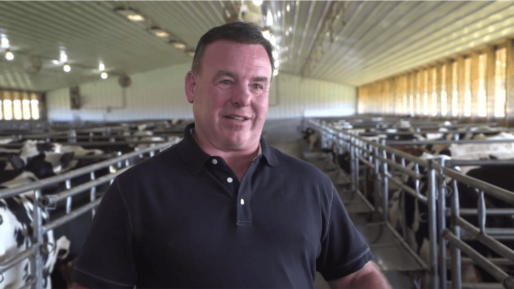 Chris Landwehr, veal farmer stands in veal barn.