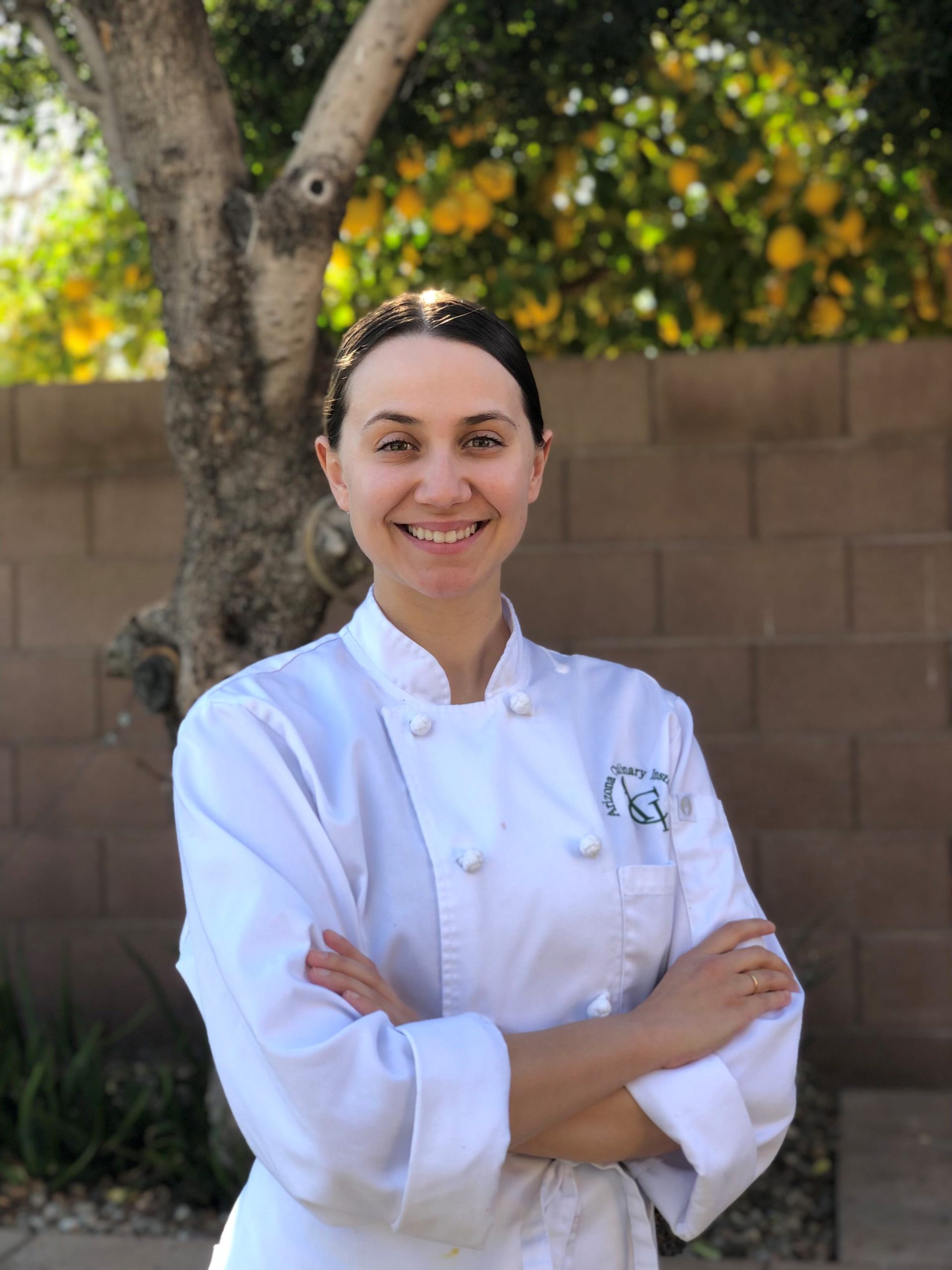 Leslie Lecomte stands in her chef coat as the winner of the 2022 National Collegiate Veal Compeition.