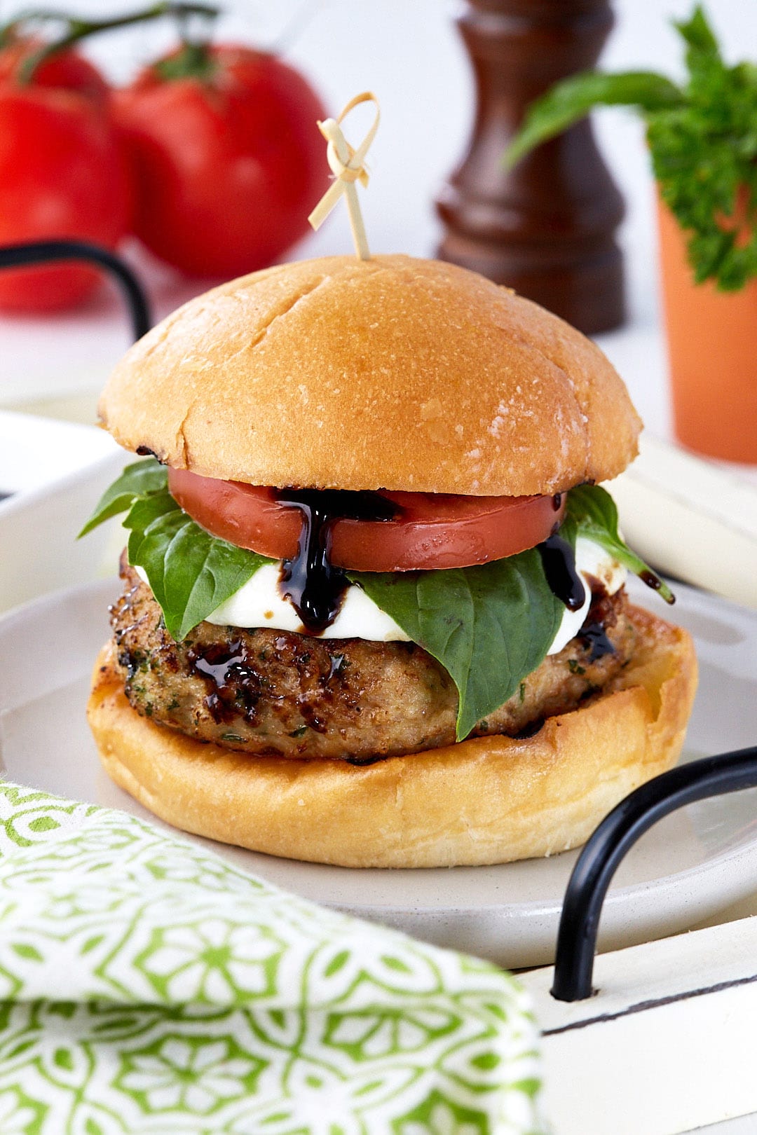 Thick juicy veal burgers served on a fresh bun with thick mozzarella, basil, tomato, and balsamic glaze.